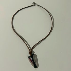 Fossil necklace leather cord and a black and silver pendant